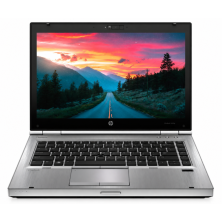 HP EliteBook 8470p reacondicionado, vista frontal con la pantalla encendida mostrando una carretera al atardecer